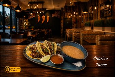 Gluten-free chorizo tacos served with beans and salsa in a cozy restaurant.