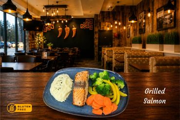 Grilled salmon fillet, with a lightly charred crust. Tender, flaking easily with each bite, and it is brushed with a hint of lemon and fresh herbs and a touch of garlic. Alongside roasted veggies, simple, vibrant and absolutely delicious.