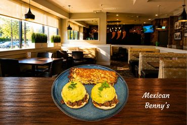 Two Benedict eggs topped with chorizo, avocado sauce and a side of hashbrowns.