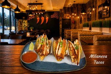 Grilled chicken tacos served with salsa in a cozy restaurant setting.