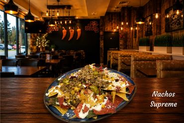 Crispy tortilla chips loaded with melted Mexican cheese, juicy seasoned beef, fresh pico de gallo, creamy guacamole, and a generous drizzle of sour cream. Finished with sliced jalapeños for that perfect spicy kick.