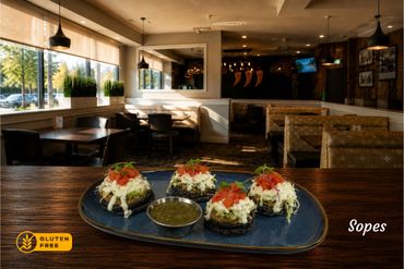 Gluten-free sopes served with fresh cheese, sour cream, fresh tomatoes and your side or salsa roja or verde.