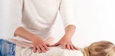 A person receiving a back massage while lying down.