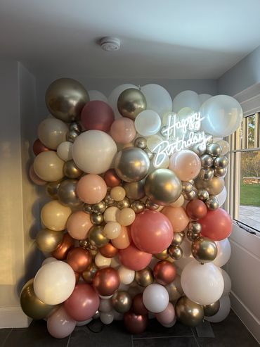 A elegant colour pallet for a surprise birthday filled with golds ands creams and a touch of coral