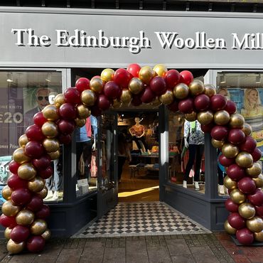 A beautiful gold and Burgundy twisted arch for the grand opening of The Edinburgh Woollen Mill