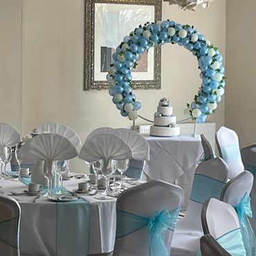 Powder blue and ivory with a hint of ivy makes this table top balloon hoop