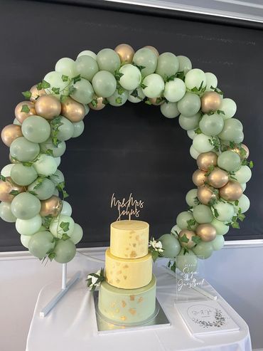 Sage green and mint with a hint of gold and ivy table top balloon hoop