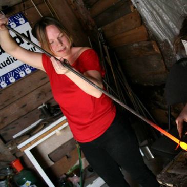 Assistant brings bit of hot glass