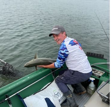 Ian Carter releasing wild chinook