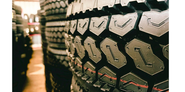Close-up of stacked tires showcasing detailed tread patterns.