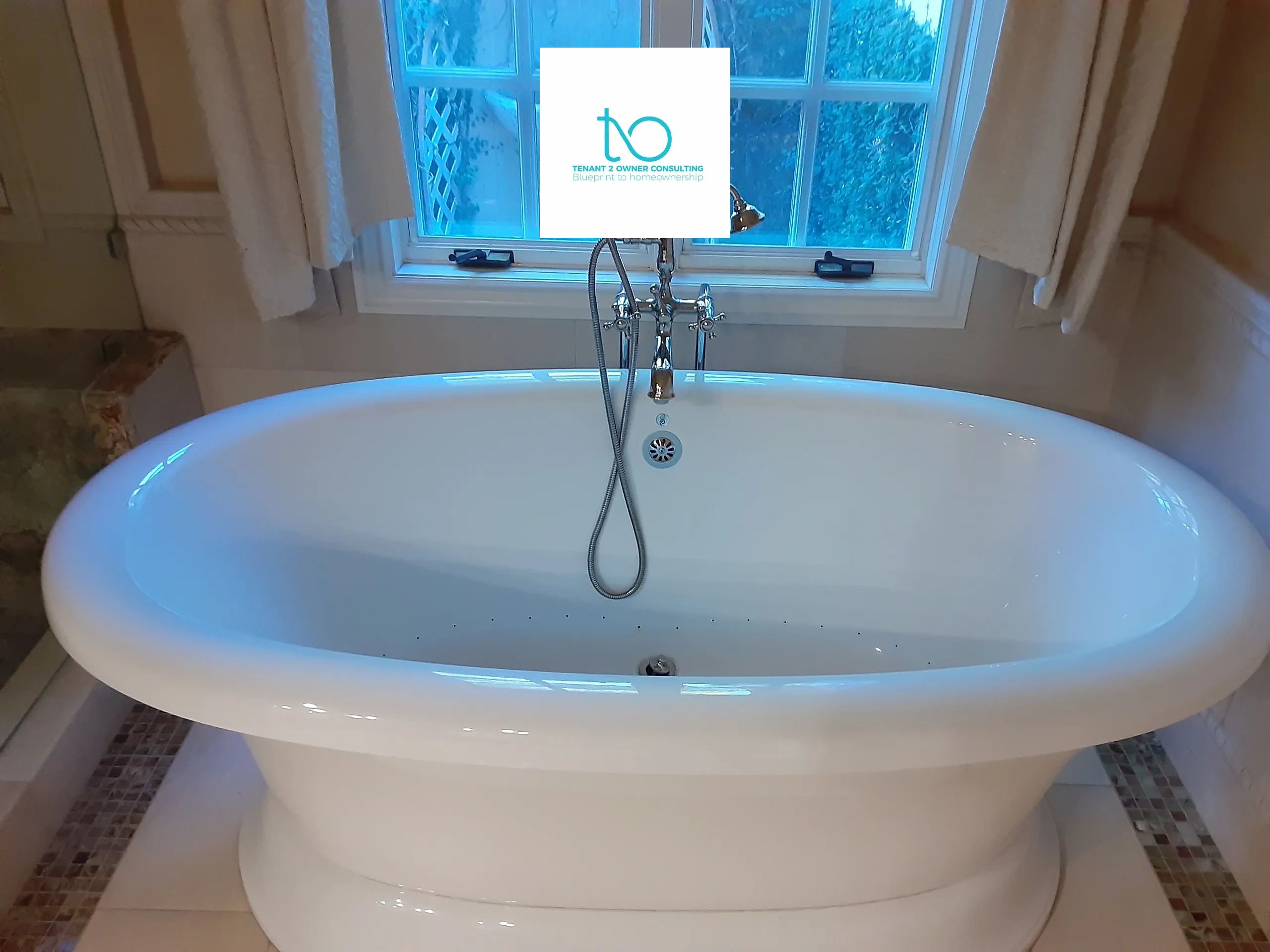 an oval bath tub next to a glass pane window