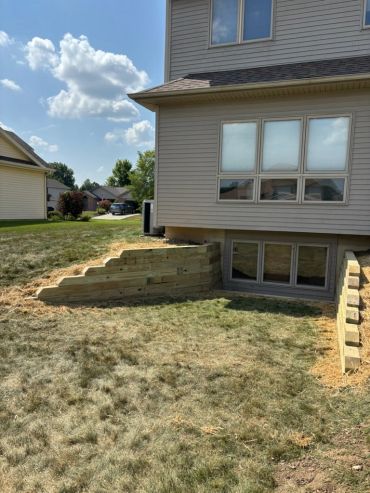 Finished timber retaining wall by Frain Landscaping in Fort Wayne, Indiana.