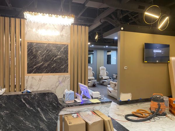Modern salon interior under construction with chairs and lighting.
