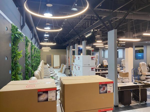 Modern salon interior with stacked boxes and ring lights.