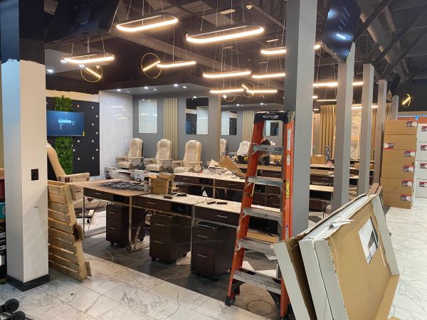 Salon under construction with chairs and lighting fixtures.