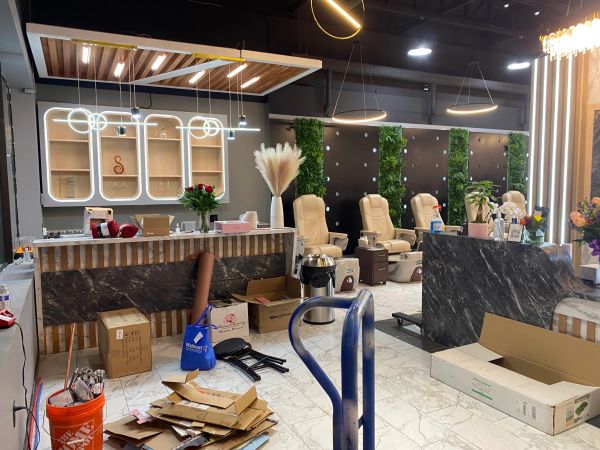 Modern beauty salon with pedicure chairs and unpacked supplies.