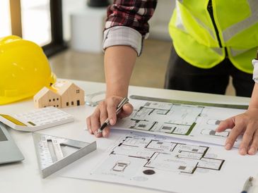 Professional engineer working on blueprints and construction plans