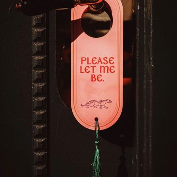 Door hanger with "Please let me be" text and a leopard illustration.