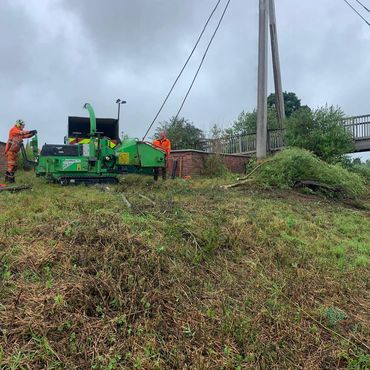 Two persons using a chipper