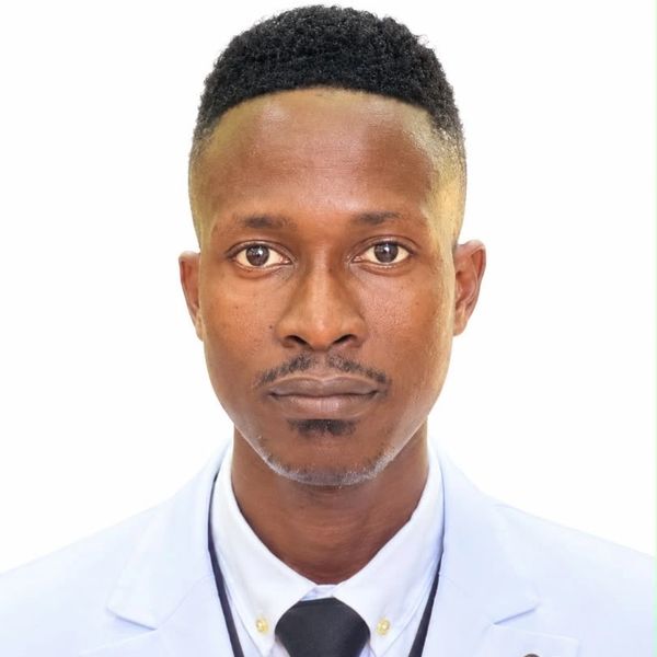 Portrait of a man in a white lab coat and tie.