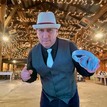 DJ Daniel wearing a Mexico cap with social media handles on black background.