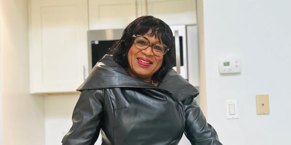 a woman standing and smiling at camera