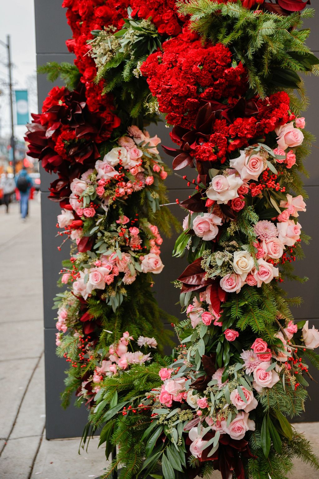 fresh floral photo frame. red roses, red carnations, pink roses, big red flower filled bow
