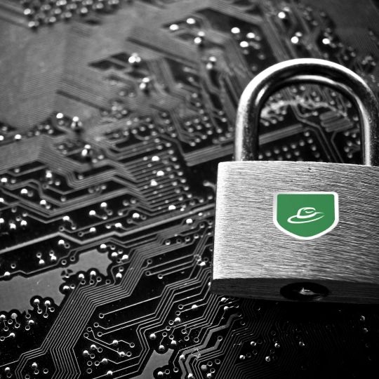 Image of a padlock with the Greenhat Solutions Brand sitting on a circuitboard