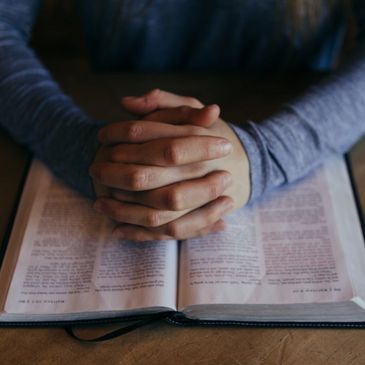 A Christian praying with the bible