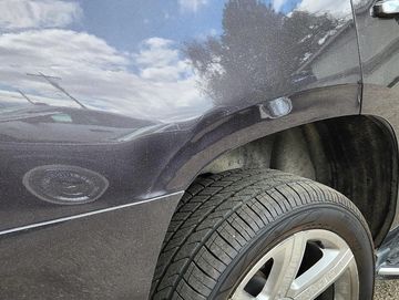 Car with dent on panel needing repair