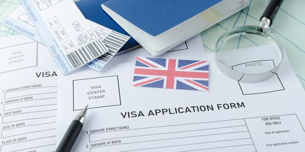 Visa application form, passports, tickets,English flag, magnifying glass on the world map