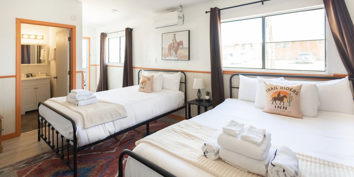 Bright room with two beds and rustic decor.