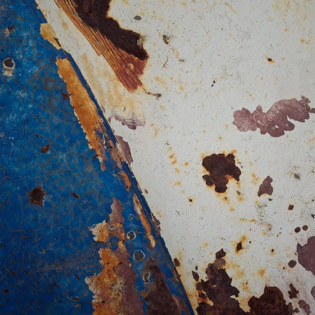 Photography close-up on an old 1963 VW Truck.  #2 in a series, featuring rust , crackled blue paint 