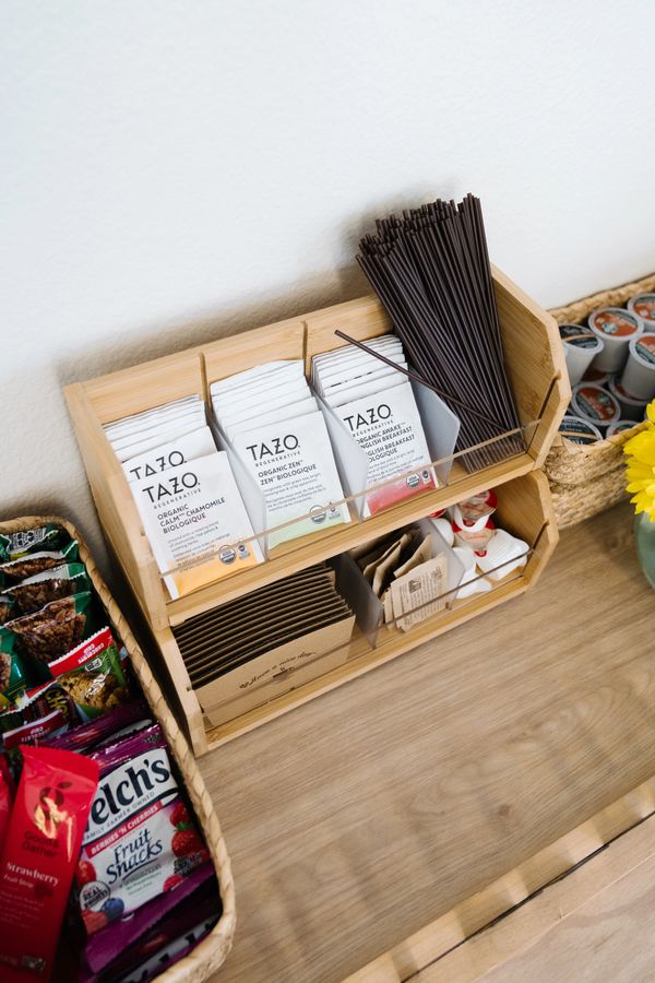 Organized tea and snack station with Tazo teas, stirrers, and snacks.