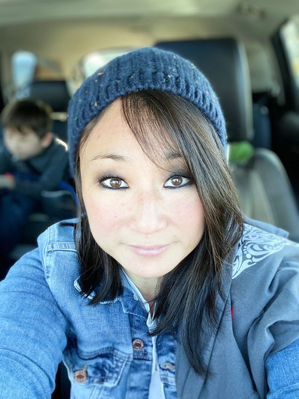 Head shot of a woman in a beanie