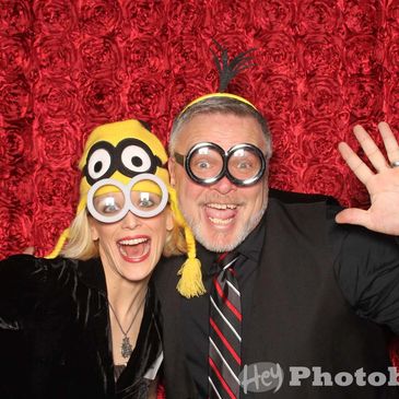Funny photo of Ivy and Chris making faces and wearing minion glasses and hats.