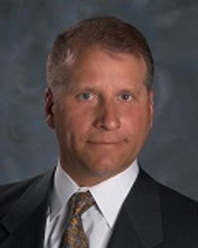 Portrait of a man in a suit and tie.