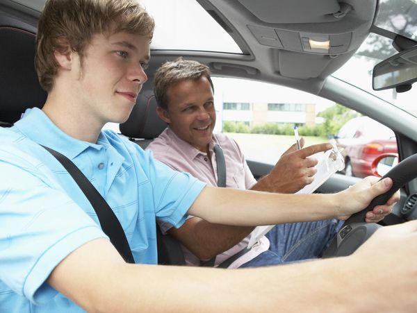 A driving instructor with a student