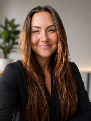 Smiling woman with long brown hair in a black top.