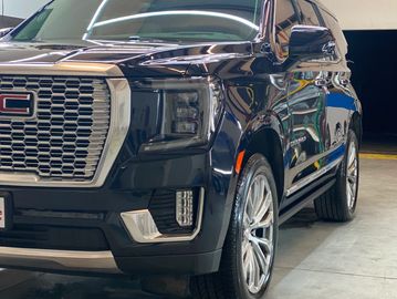 Black GMC SUV parked indoors.