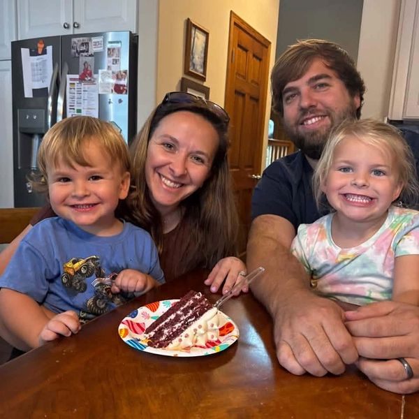 Happy family enjoying cake at the table.