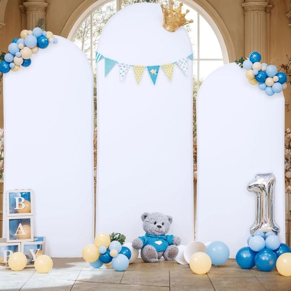 First birthday party setup with balloons, teddy bear, and decorative blocks.