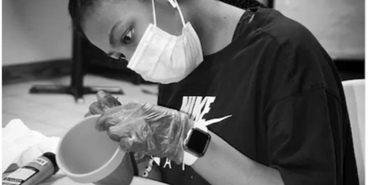 Kenna Camp 2022 student painting a flower pot