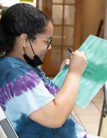 Clarke creating her affirmation painting at the Kenna Camp.