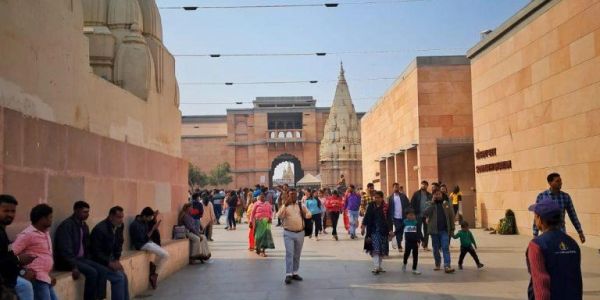 Crowded street with historical architecture and people walking.