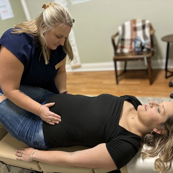 Chiropractor adjusting a patient's hip.