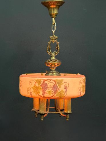 Vintage chandelier with floral design and ornate brass detailing.