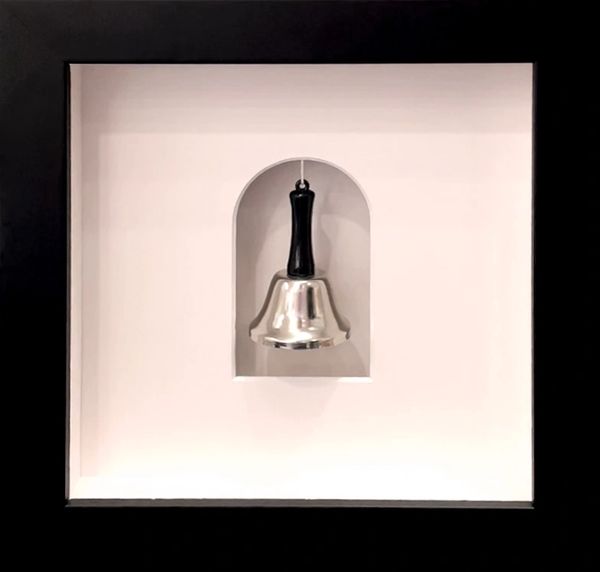 A cancer survivor's bell presented in a shadowbox