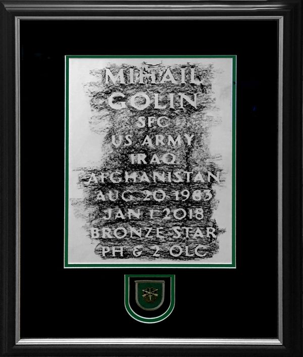 Example of a military headstone rubbing and unit patch framed using suede mats.