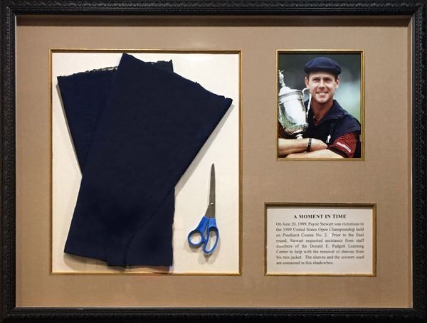 Shadowbox showcasing sleeves that Payne Stewart cut off his jacket in final round of 1999 US Open.